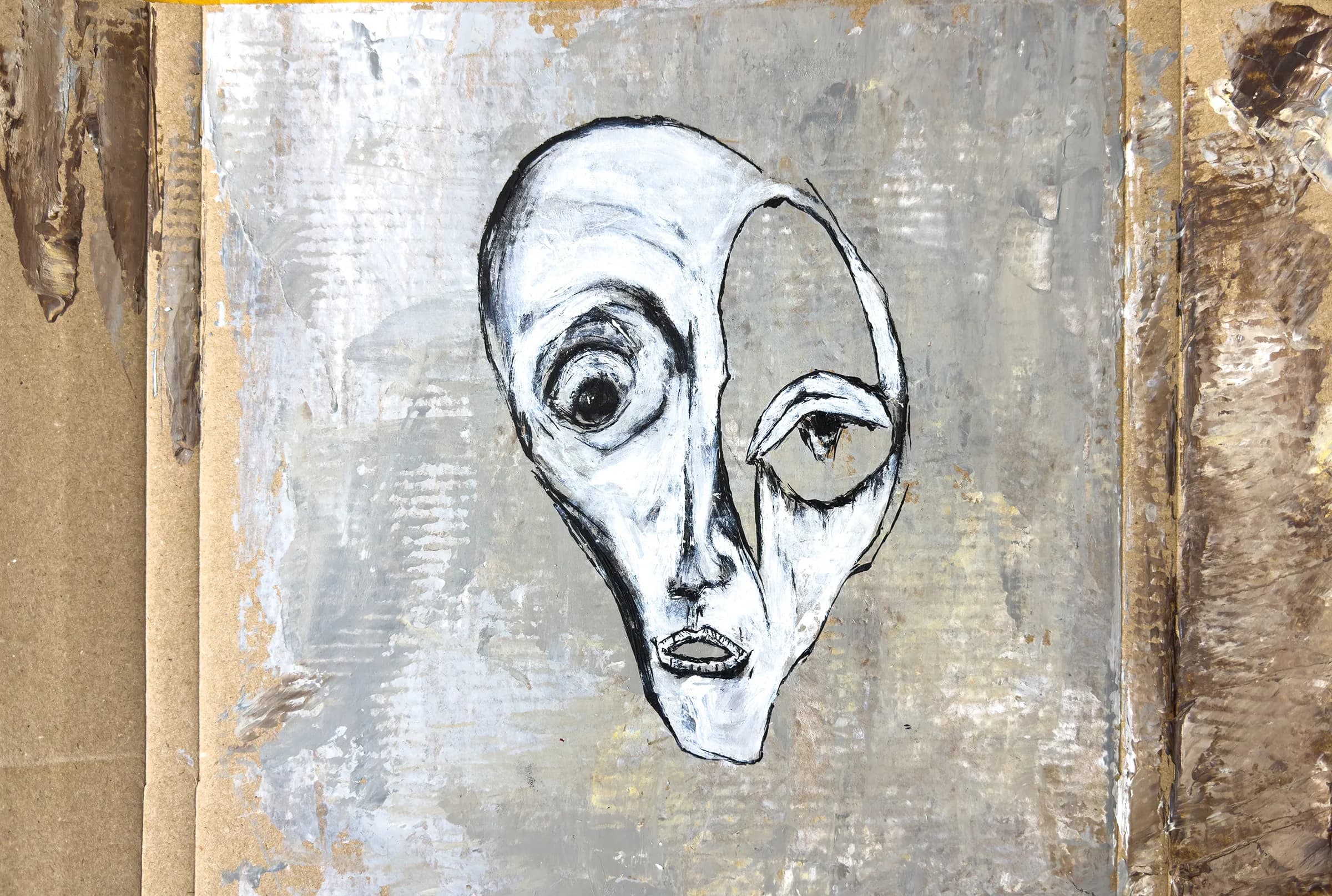 Untitled (Head XI), 2025. Paint and ink head on found cardboard by Augustus Rivers